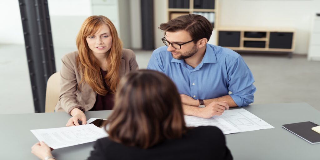 Couple going over prenuptial agreement with lawyer