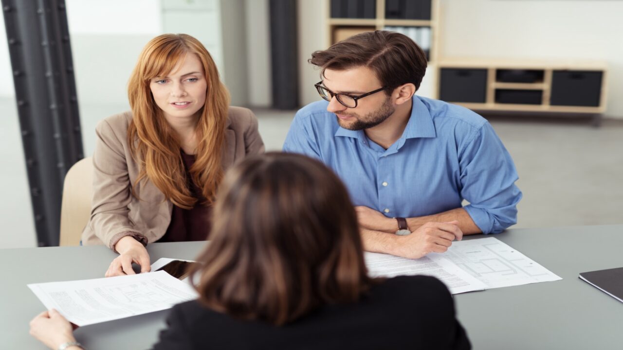 Couple going over prenuptial agreement with lawyer