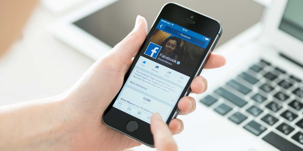 Woman looking at her husbands Facebook history