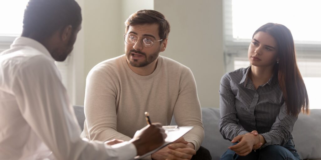 Couple talking with family law attourney