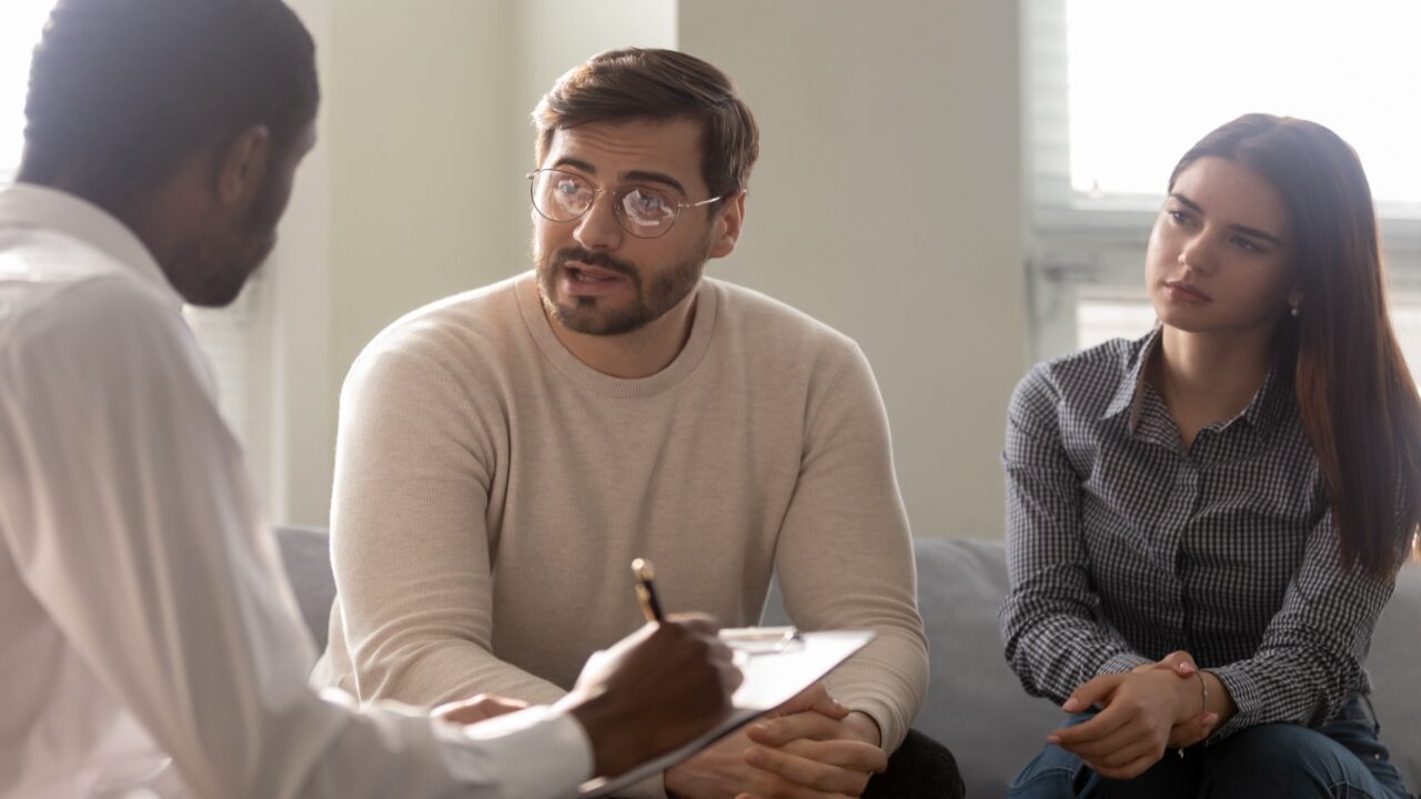 Couple talking with family law attourney