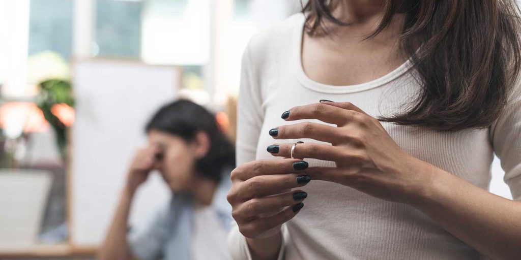 Woman taking her wedding ring off