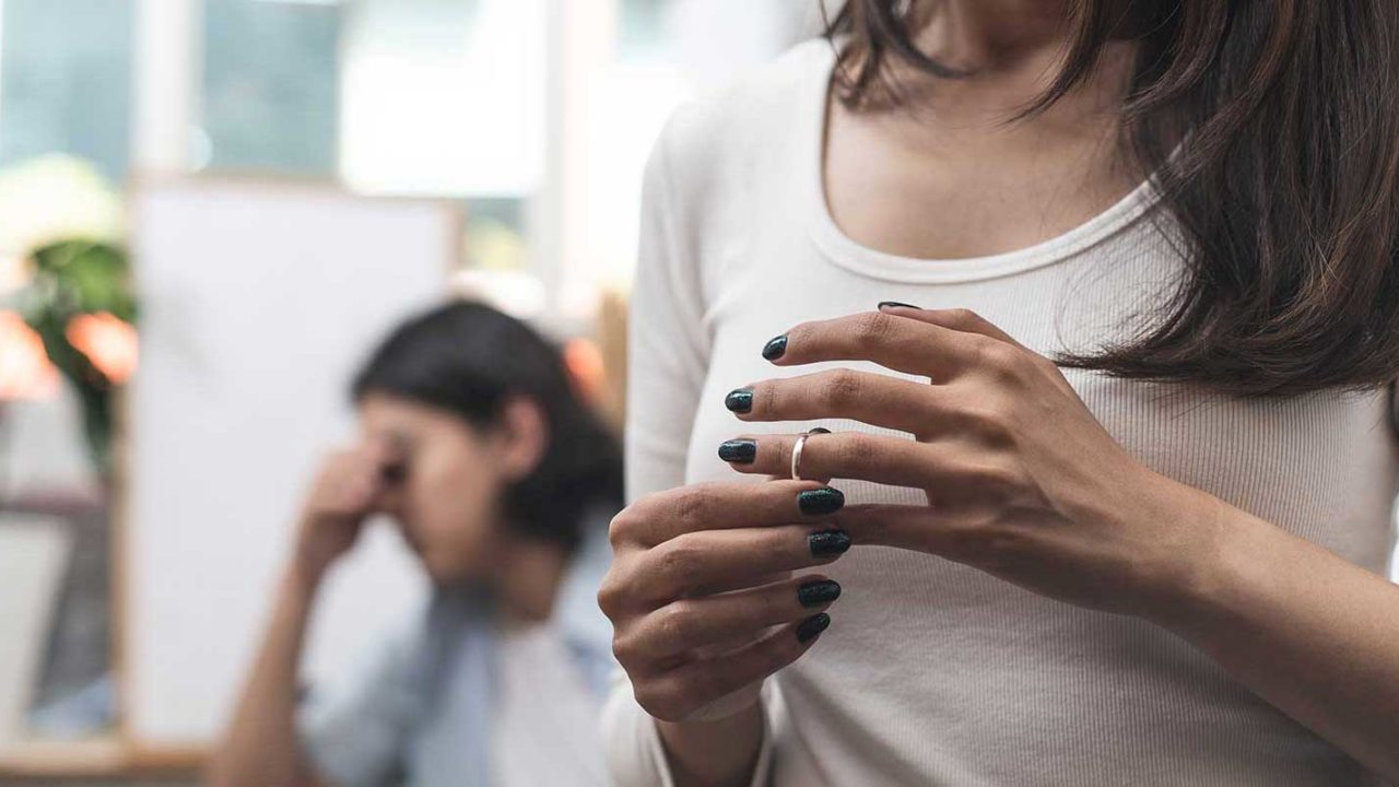 Woman taking her wedding ring off