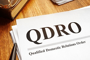 QDRO paperwork on a desk with a pen