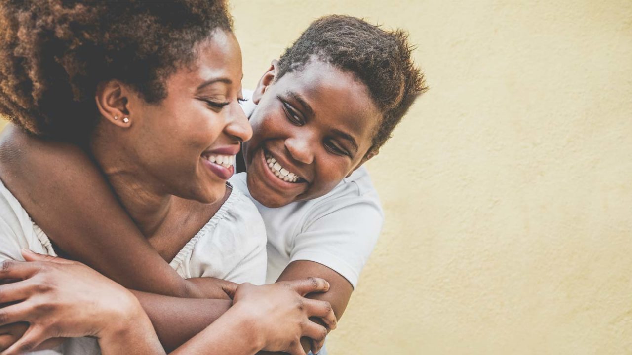 smiling mother and son hugging