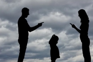 couple fighting while child standing between