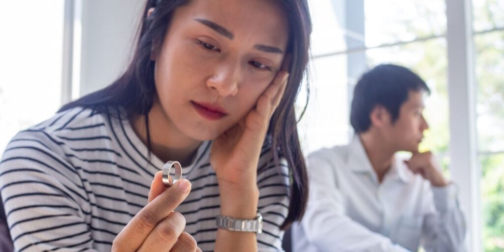 asian woman sat with the wedding ring