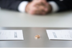 decree paper and rings on table as concept of a federal divorce