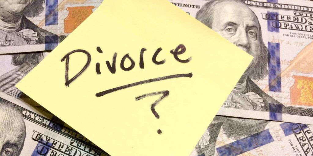 cash money and yellow post it note with text Divorce