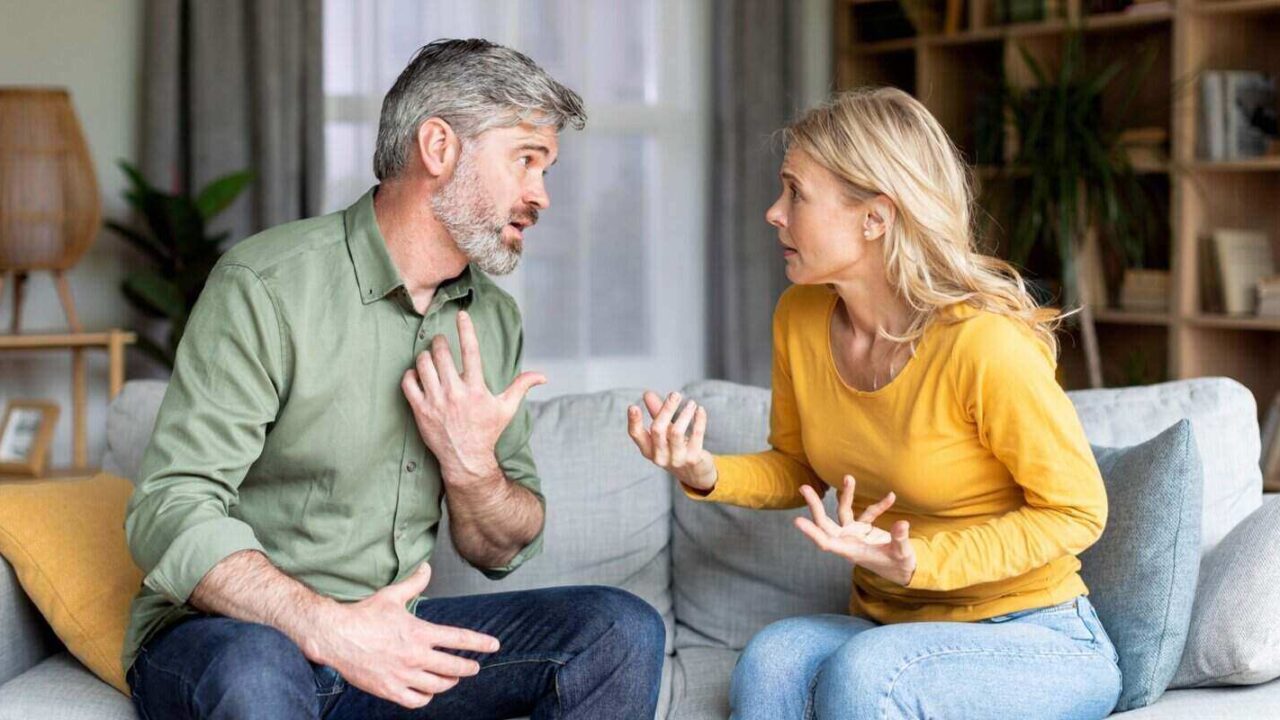 portrait of middle aged spouses arguing at home