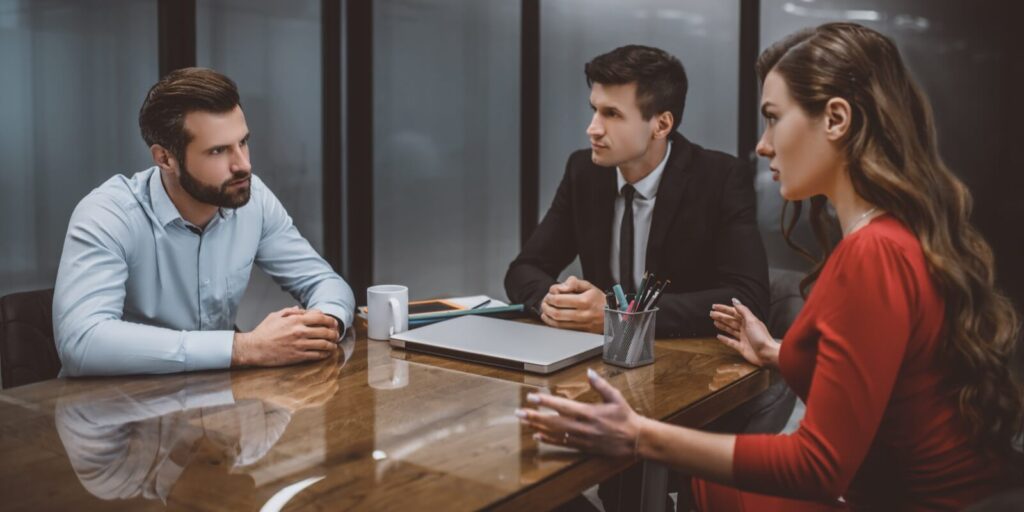man and woman looking at each other angrily while getting divorced