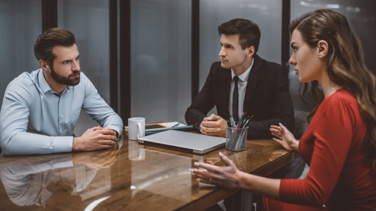 man and woman looking at each other angrily while getting divorced