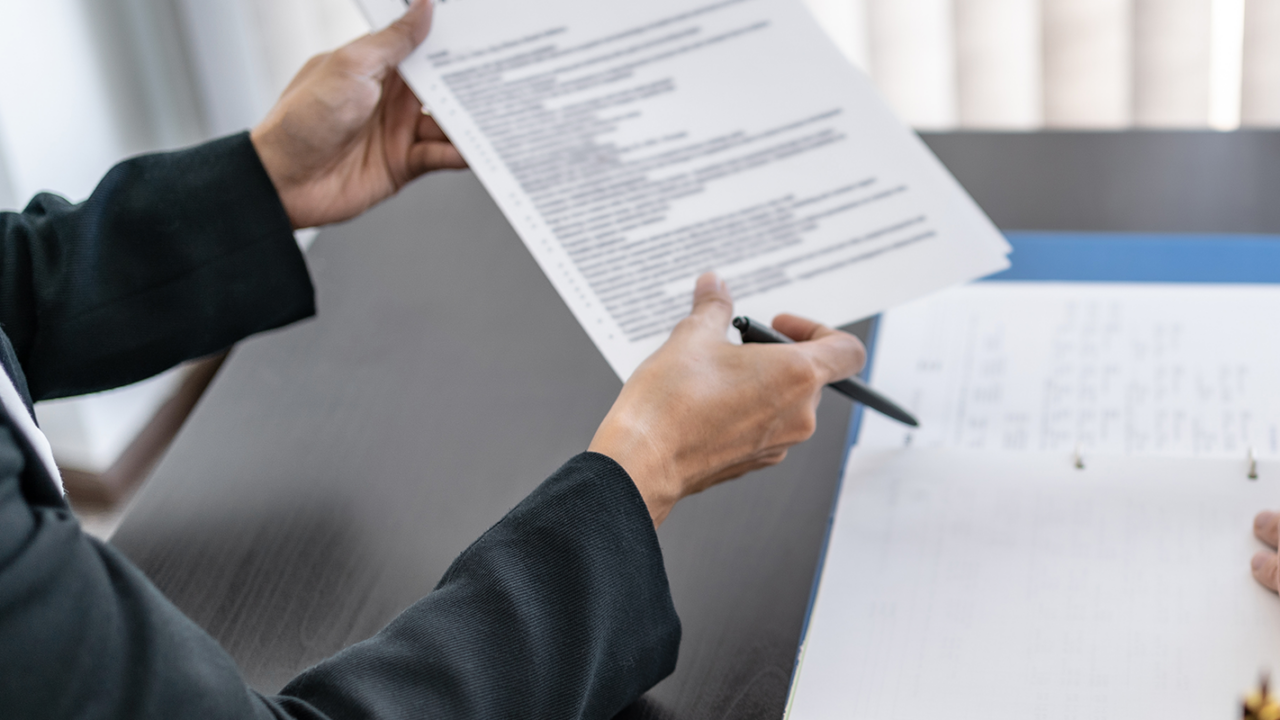 divorce lawyer showing client a divorce paperwork checklist to be completed