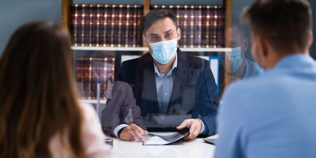 family divorce lawyer consulting family couple with face mask