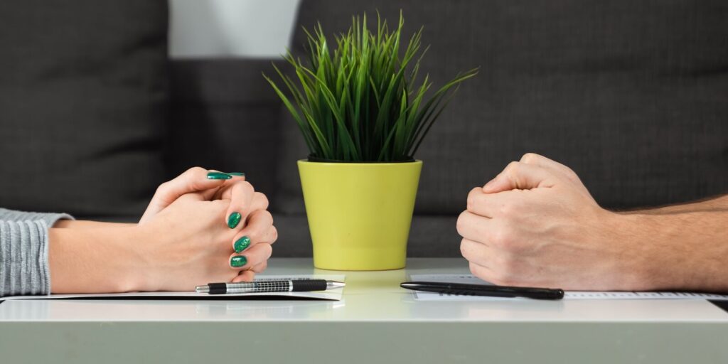 male and female hands are folded opposite each other