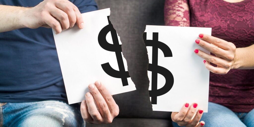 man and woman holding ripped paper with dollar sign