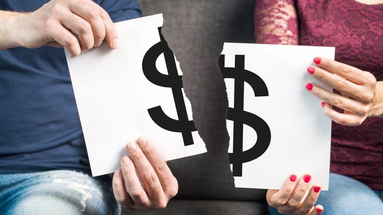 man and woman holding ripped paper with dollar sign