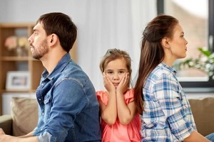 couple facing opposite while child sitting in between