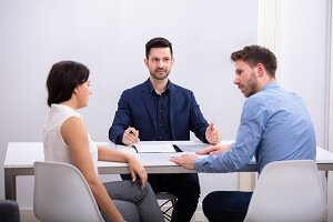 couple sitting in front of judge