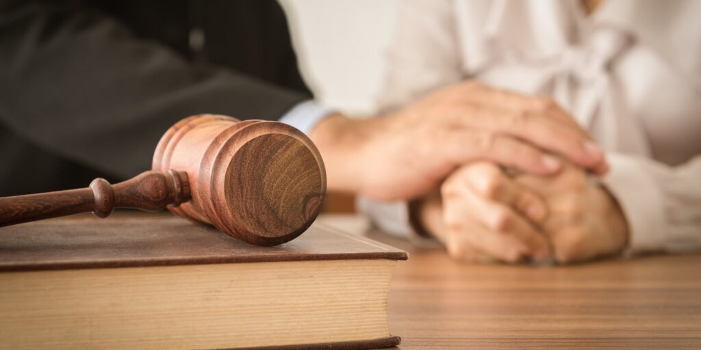 law books with attorney or lawyer provide legal advice and consoling to his clients in background