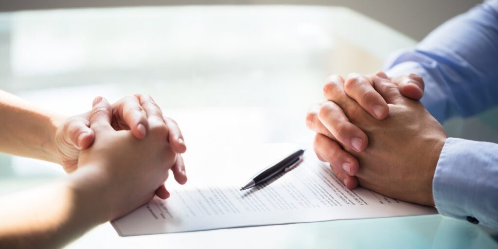 two businesspeople hand with document