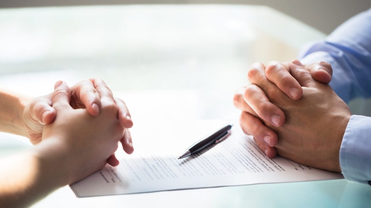 two businesspeople hand with document