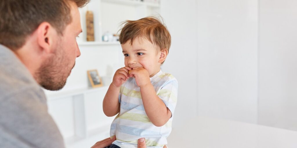 father takes care of his son with biscuit