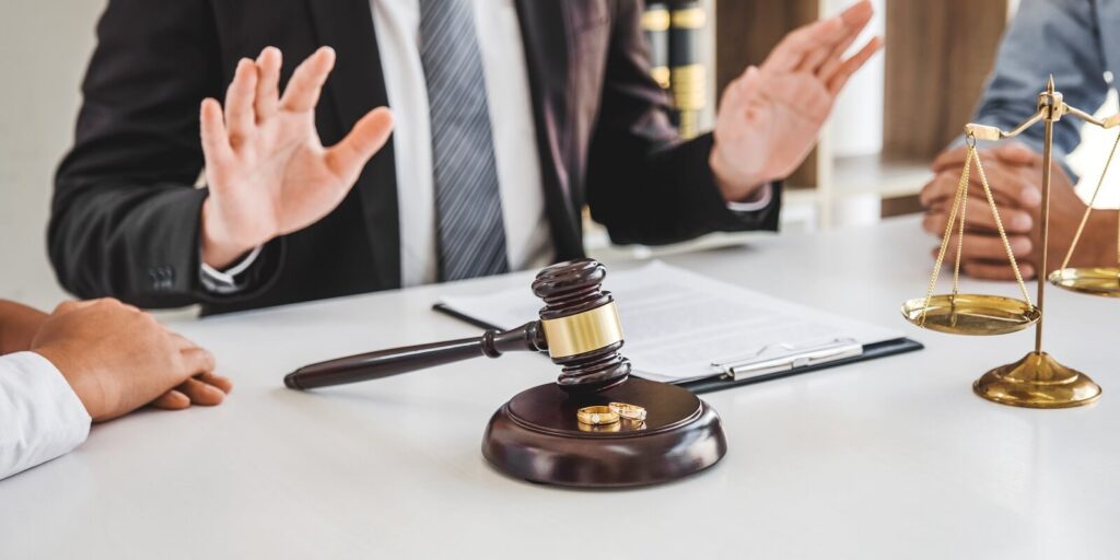 husband and wife during divorce process with male lawyer counselor and signing of divorce contract