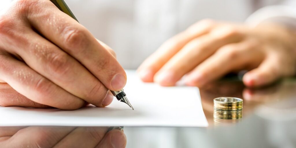 man signing divorce papers