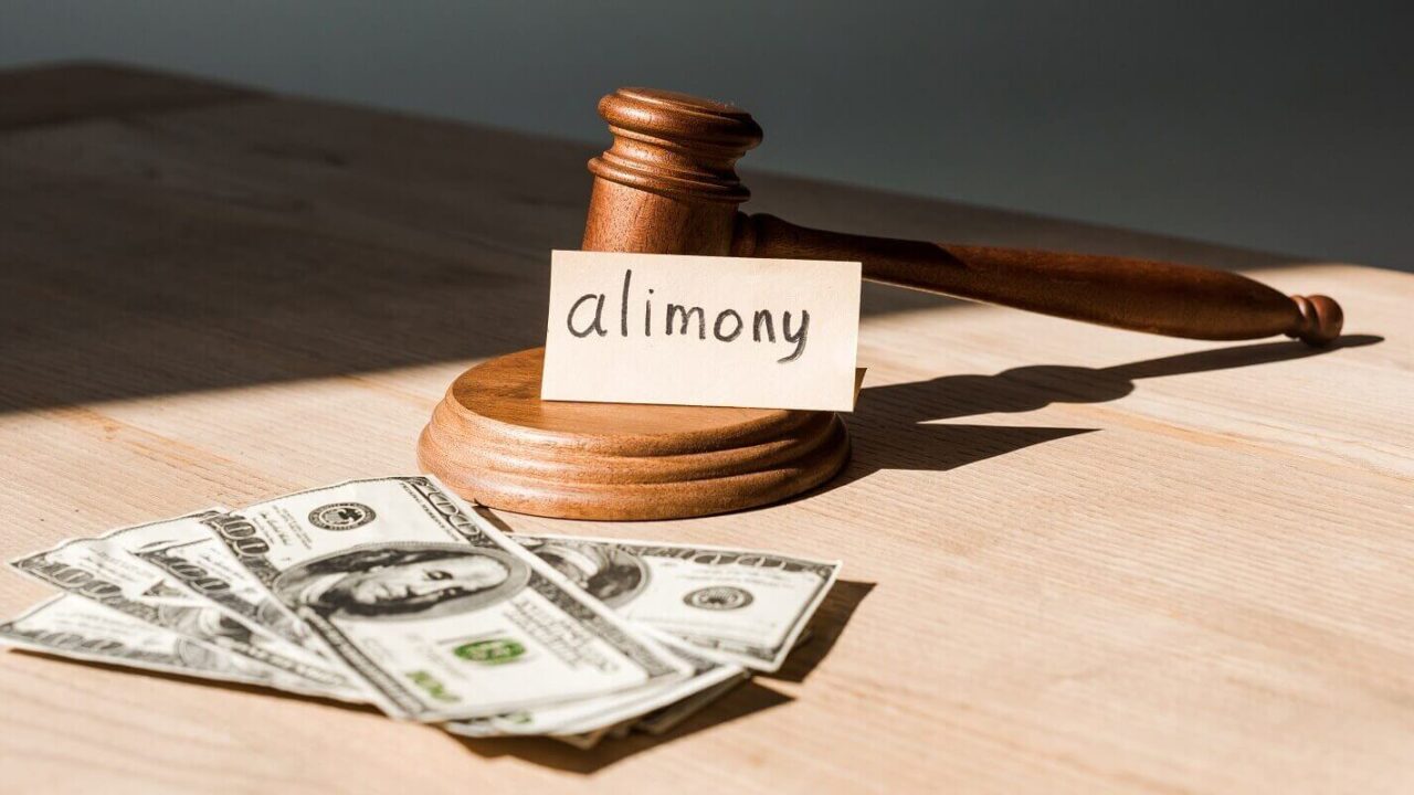 gavel near dollar banknotes and paper with alimony lettering on table