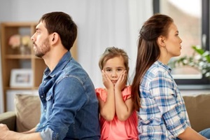 unhappy father, mother and sad little daughter at home