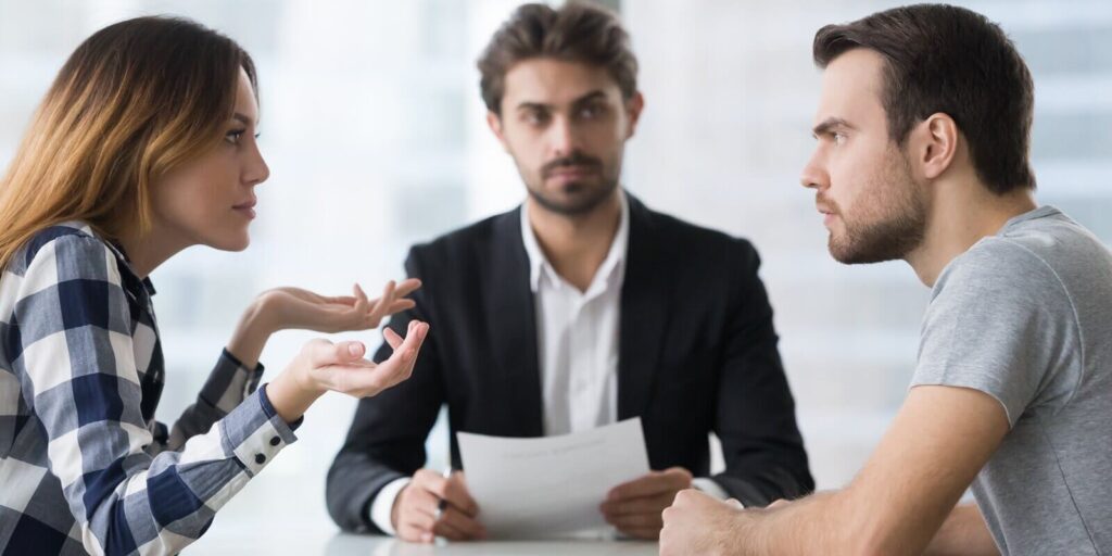 spouses split up disputing about divorce settlement in lawyers office