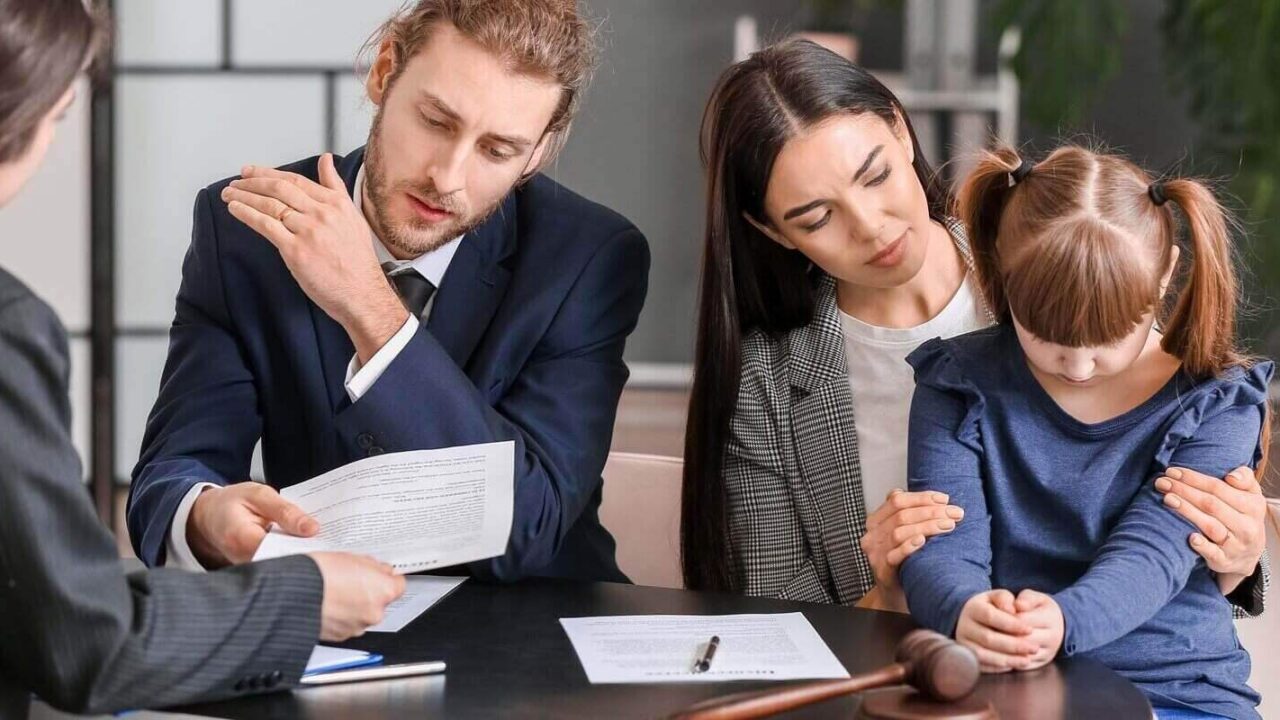 young couple and their daughter visiting divorce lawyer in office