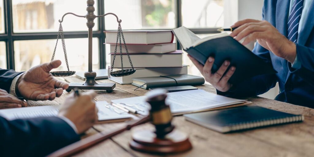 judge consulting or discussing contract documents with clients Businessmen in office meeting with new clients sharing legal advice
