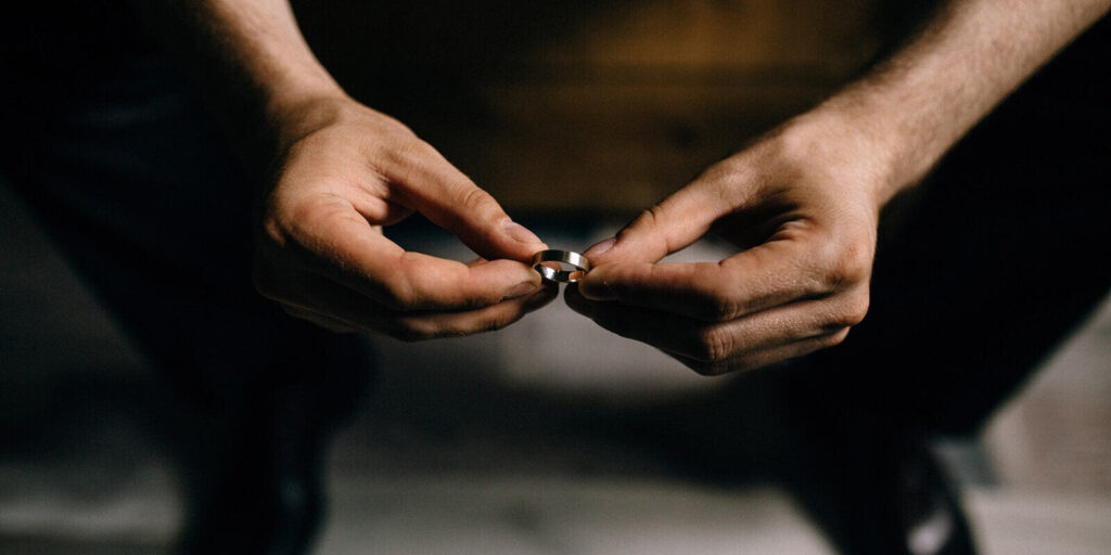 man holds rings