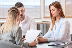 young couple visiting divorce lawyer in office