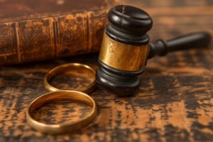 legal concept of marriage and divorce with gavel and rings