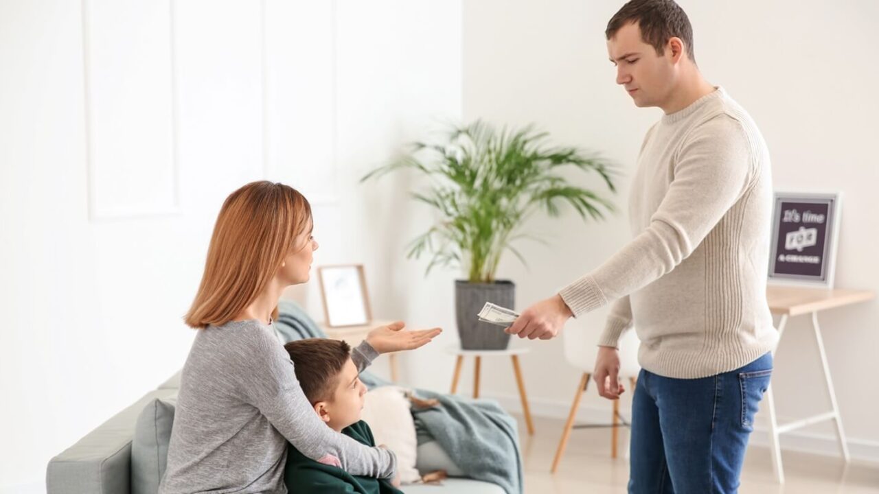 man giving alimony to his ex-family at home