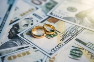 wedding rings on dollar bills