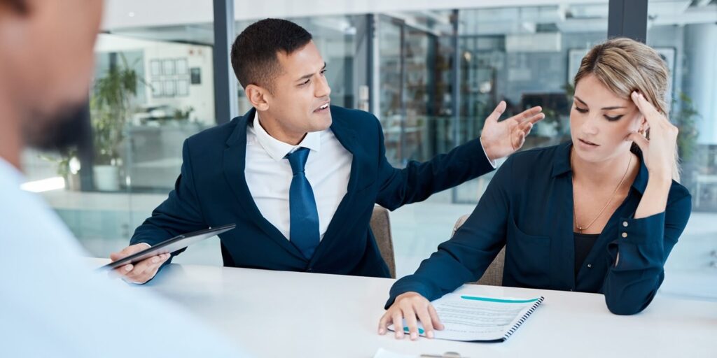 fight and divorce lawyer at work bullying a person in a meeting due to a mistake and office politics in the company