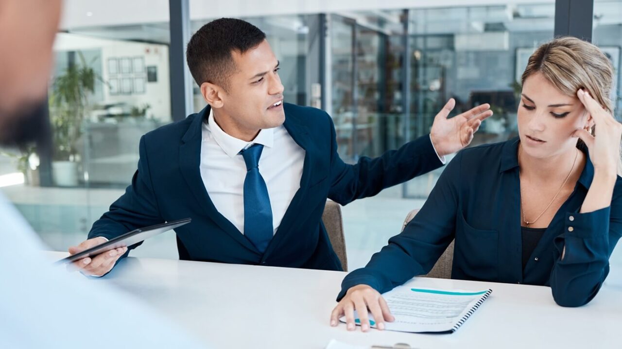 fight and divorce lawyer at work bullying a person in a meeting due to a mistake and office politics in the company