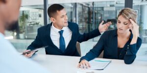 fight and divorce lawyer at work bullying a person in a meeting due to a mistake and office politics in the company