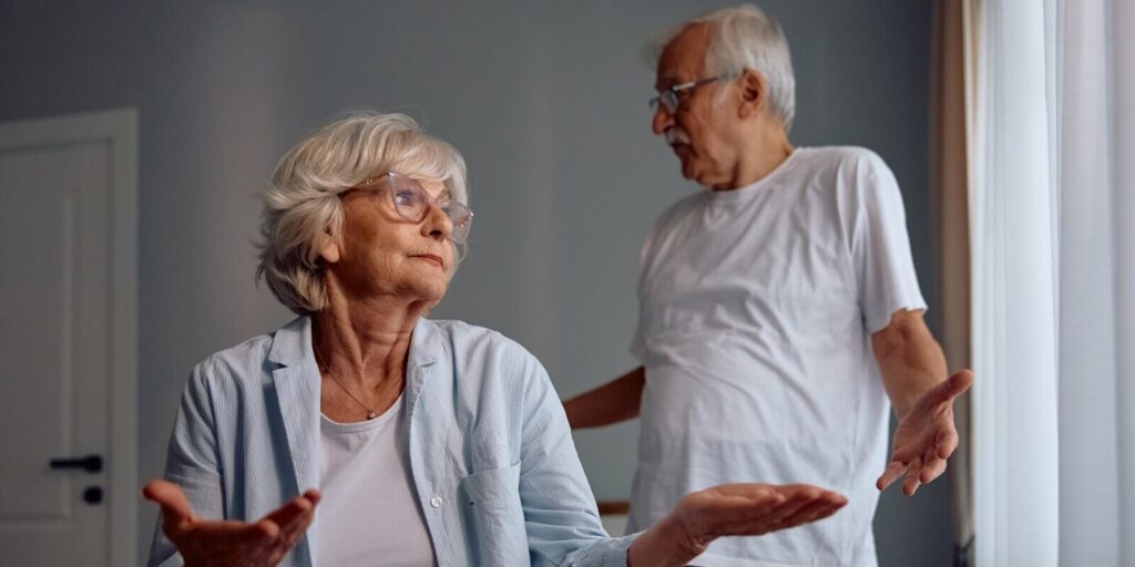 senior woman having an argument with her husband in bedroom