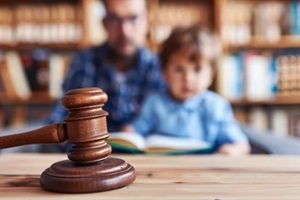 legal judge s gavel close up with blurred child in background