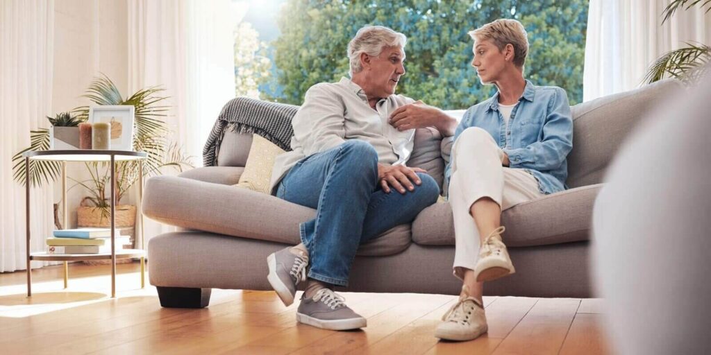 senior couple, serious talk and communication about problems and marriage issues while sitting on the sofa at home