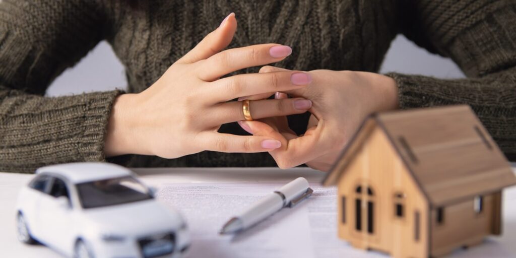 woman removes a wedding ring, property section, divorce