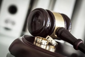 divorce concept with gavel and wedding rings