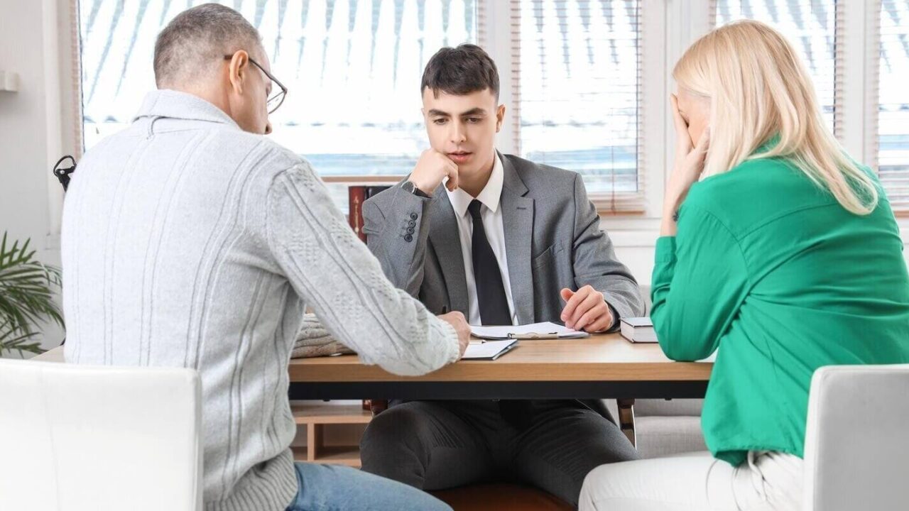 annulment divorce lawyer with mature couple signing document in office in Maryland