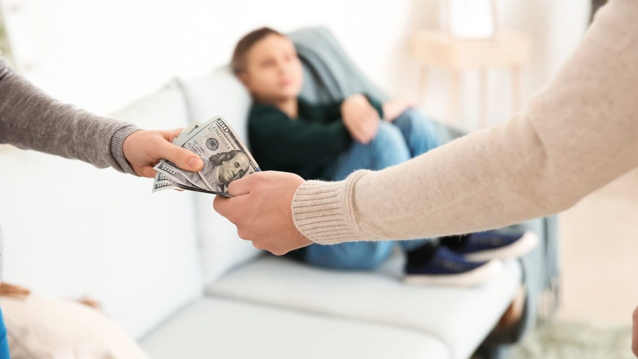 man giving alimony to his ex-wife at home