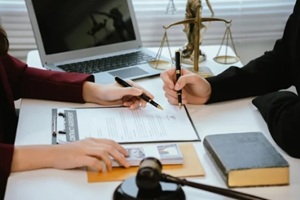 professional lawyers consult with clients in the office on legal agreements
